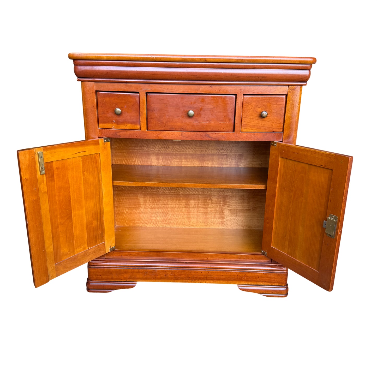 Base detail of wooden cupboard showing moulded plinth and bracket feet
