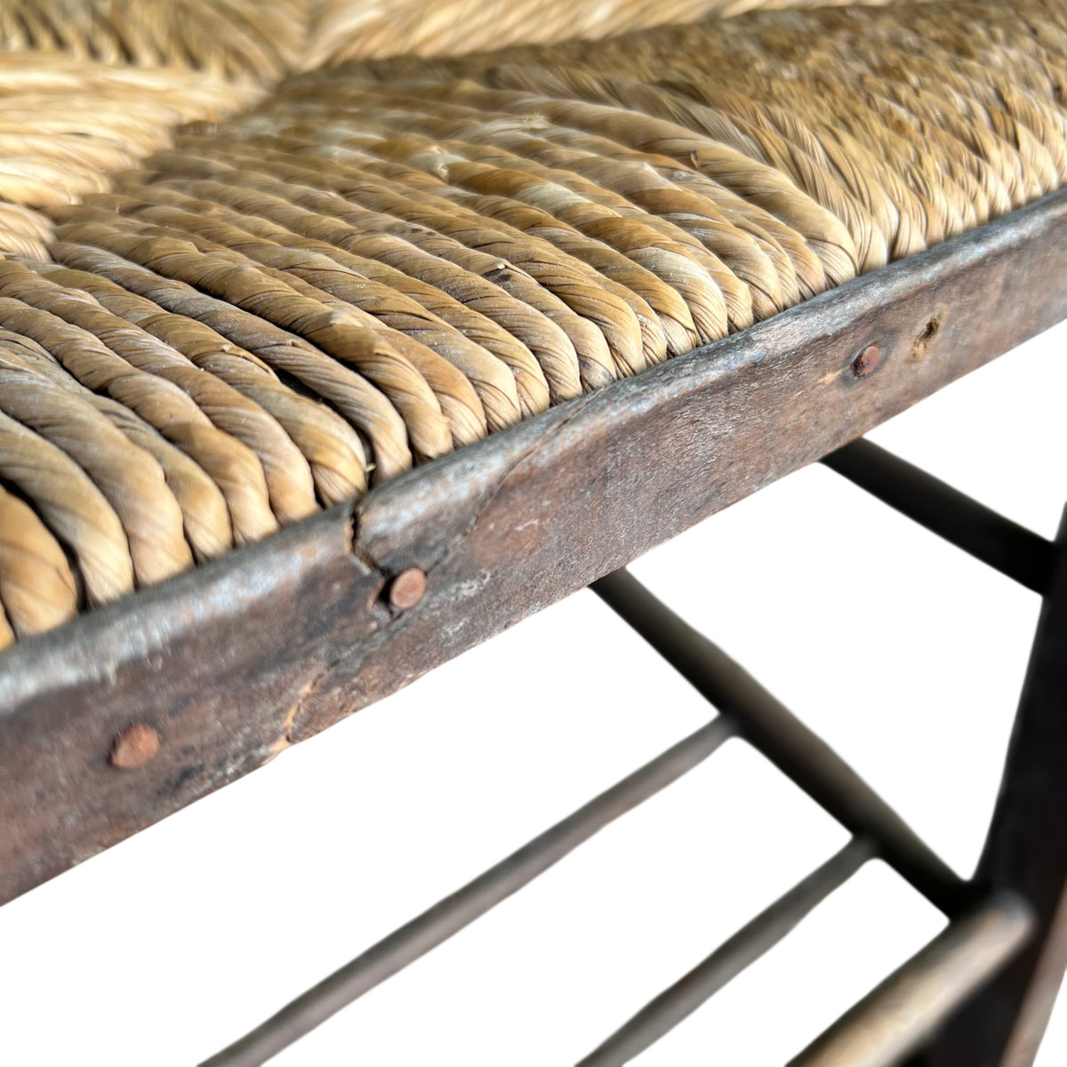 Top-down view of rush seat and round front chair post