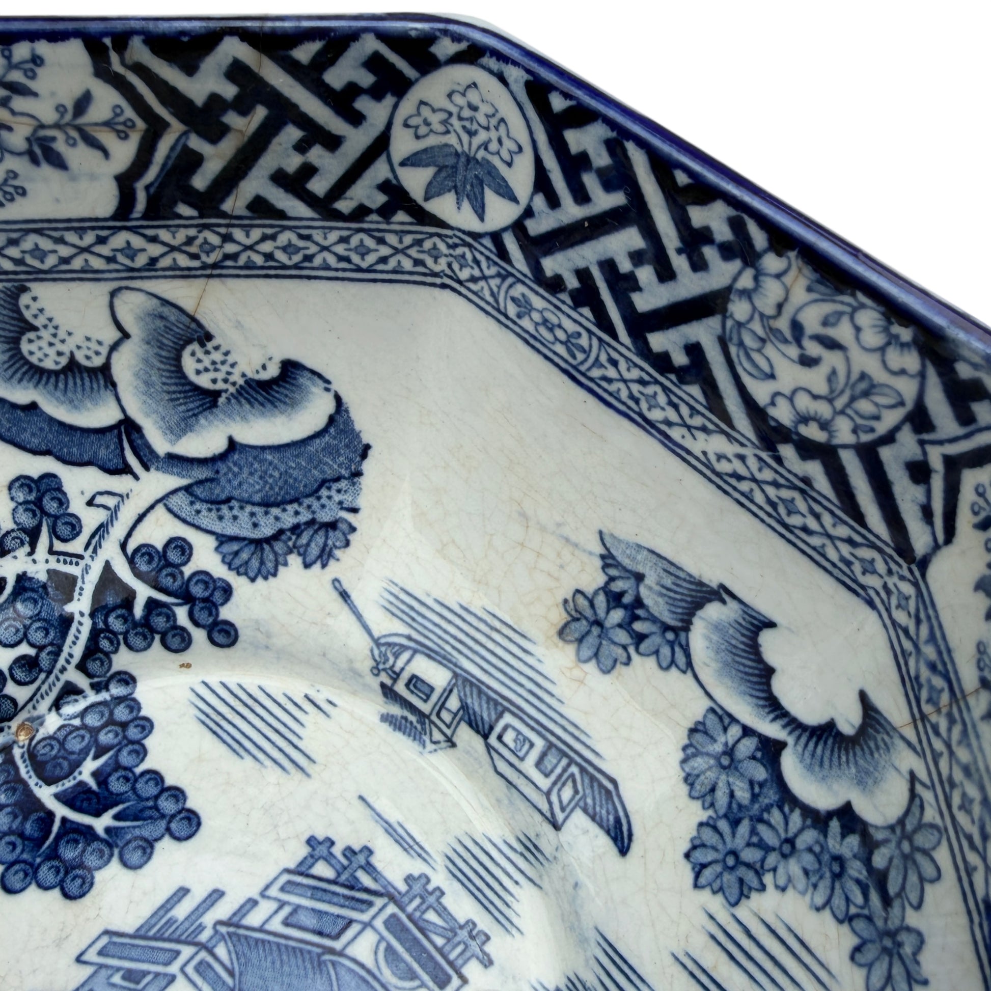 Detail of blue floral and medallion border decoration on transferware bowl rim