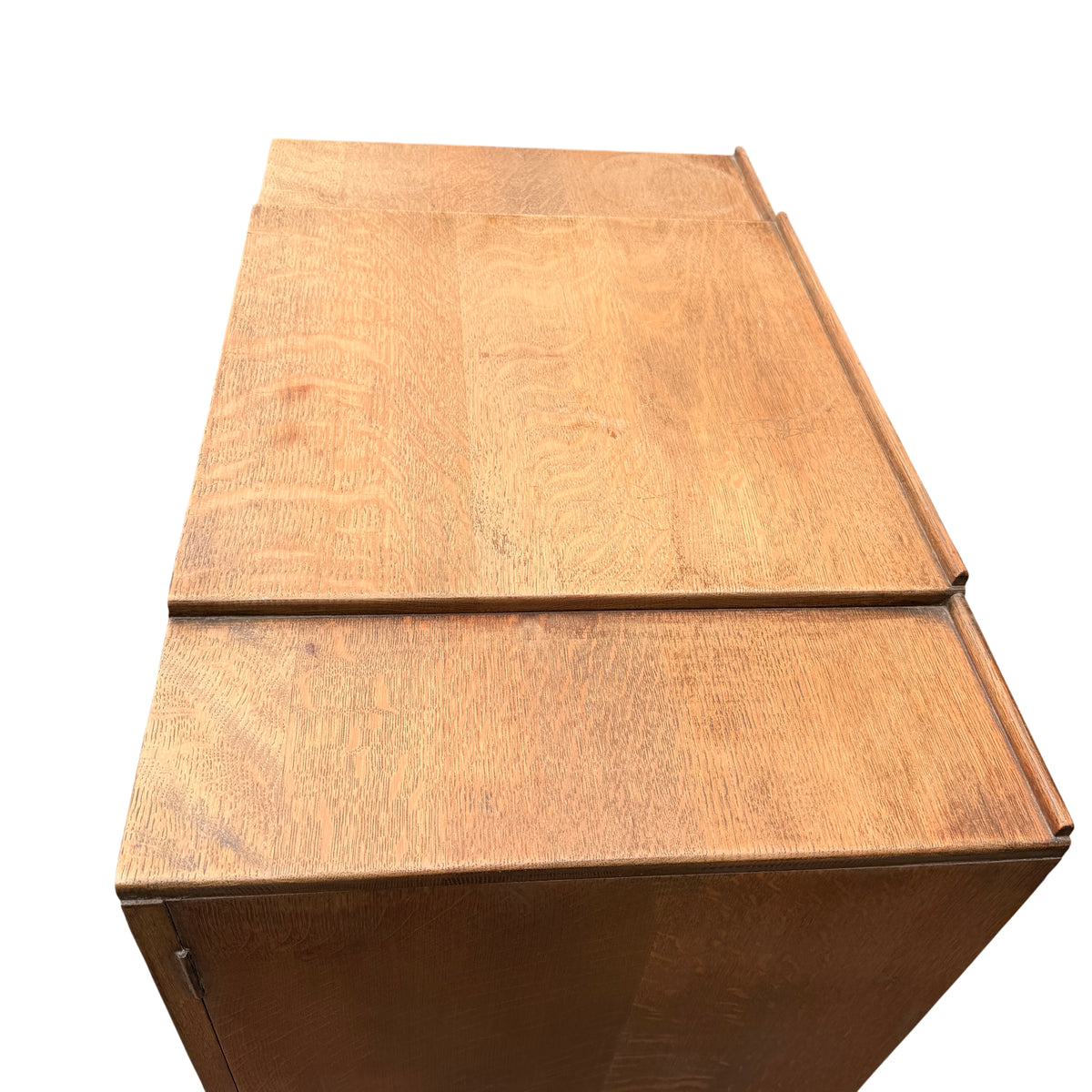 Base of oak linen press showing turned bun feet and plinth