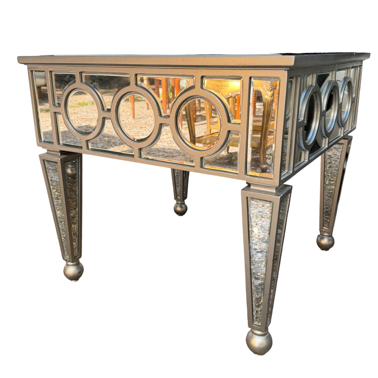 Pair of glass top end tables with decorative mirrored frames in silver