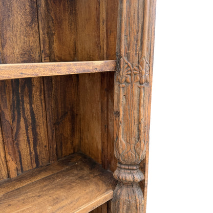 Lower section of carved oak bookcase showing shelf and base plinth