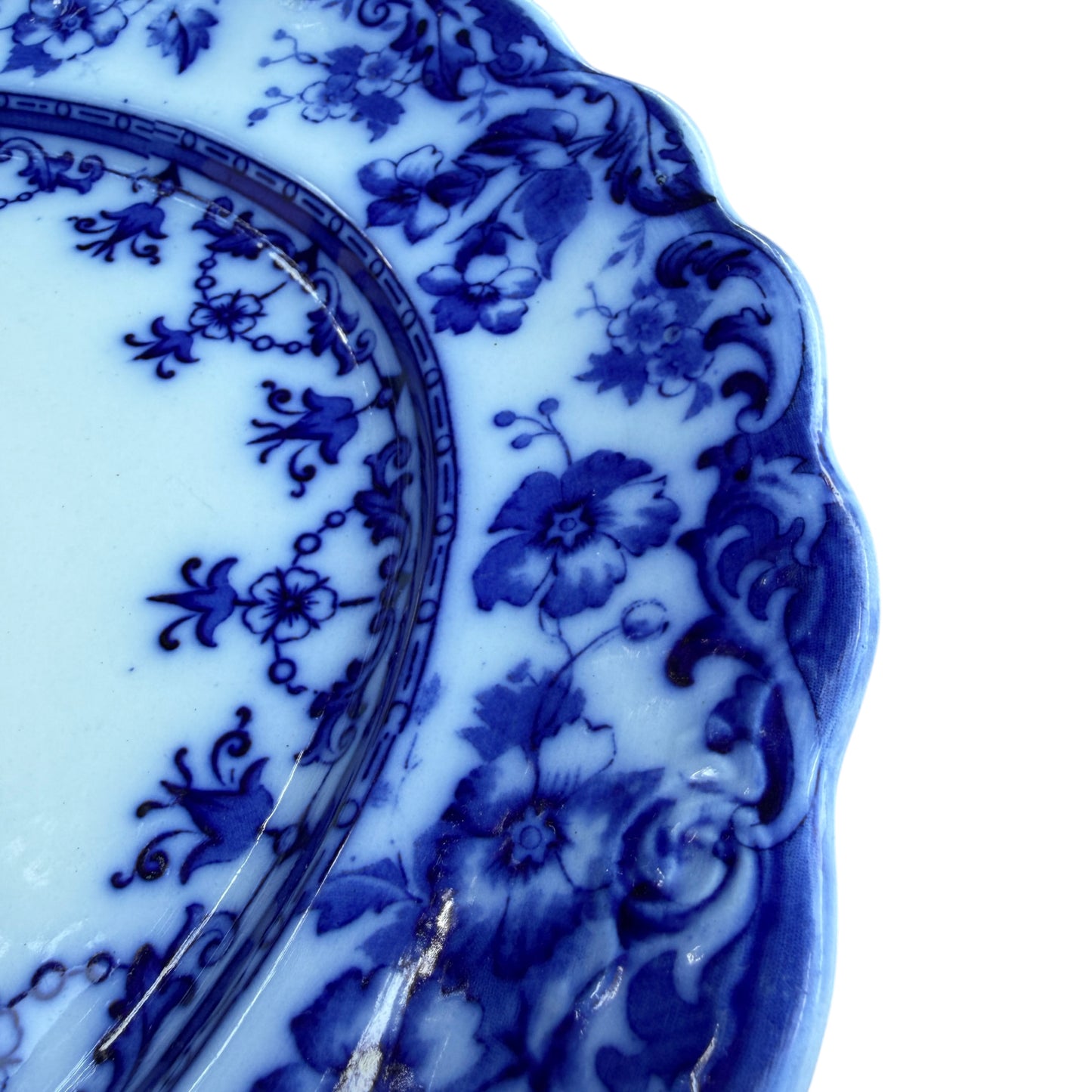 Edge detail showing scalloped rim and printed blue transfer decoration on platter