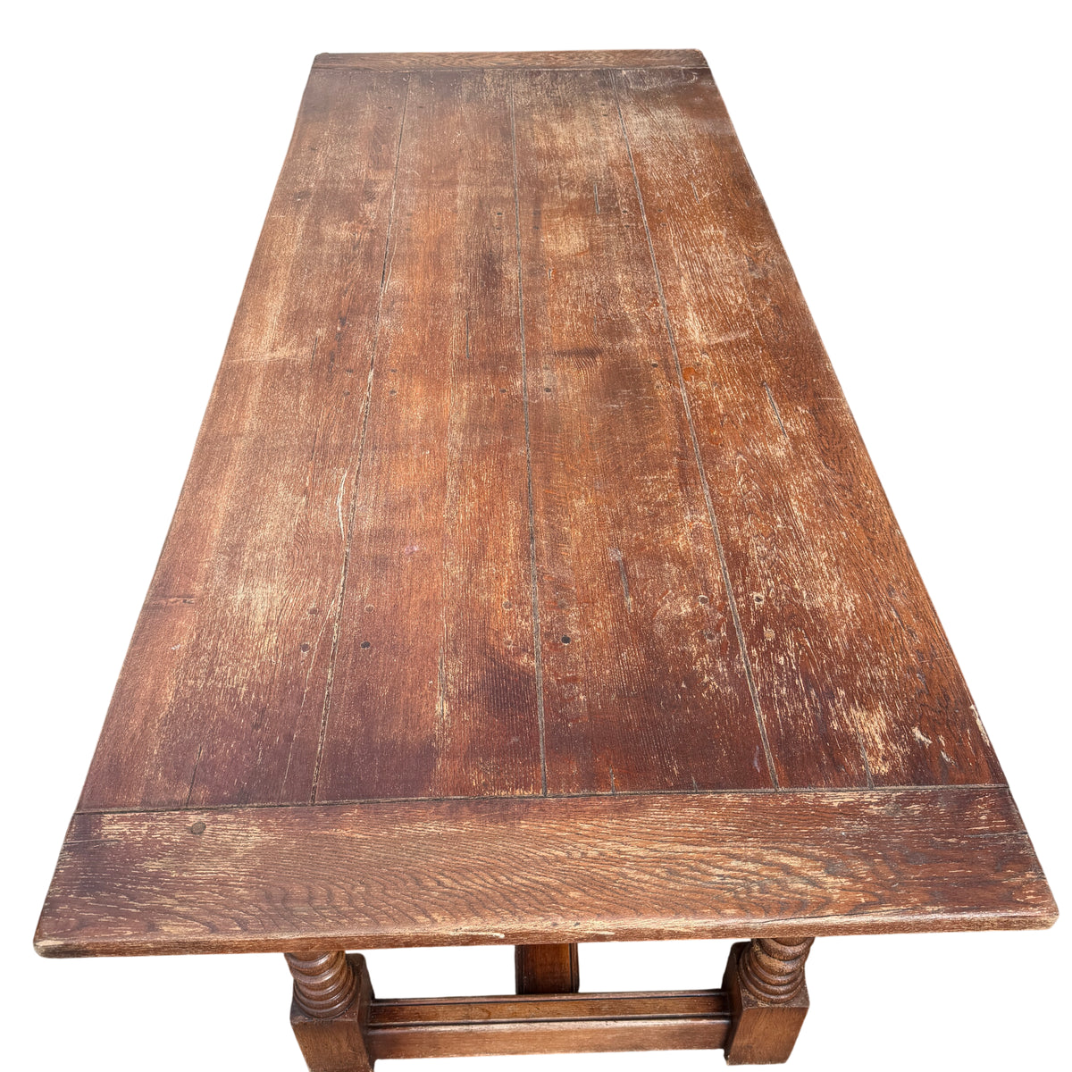 Underframe view of oak refectory table showing stretcher and turned legs