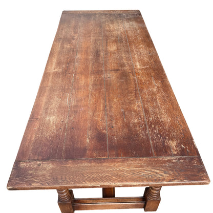 Underframe view of oak refectory table showing stretcher and turned legs
