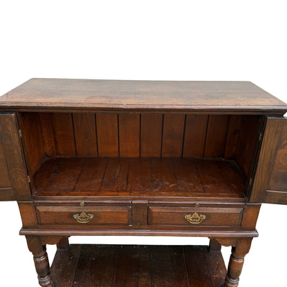 Plank base shelf of oak cabinet on stand with visible surface wear