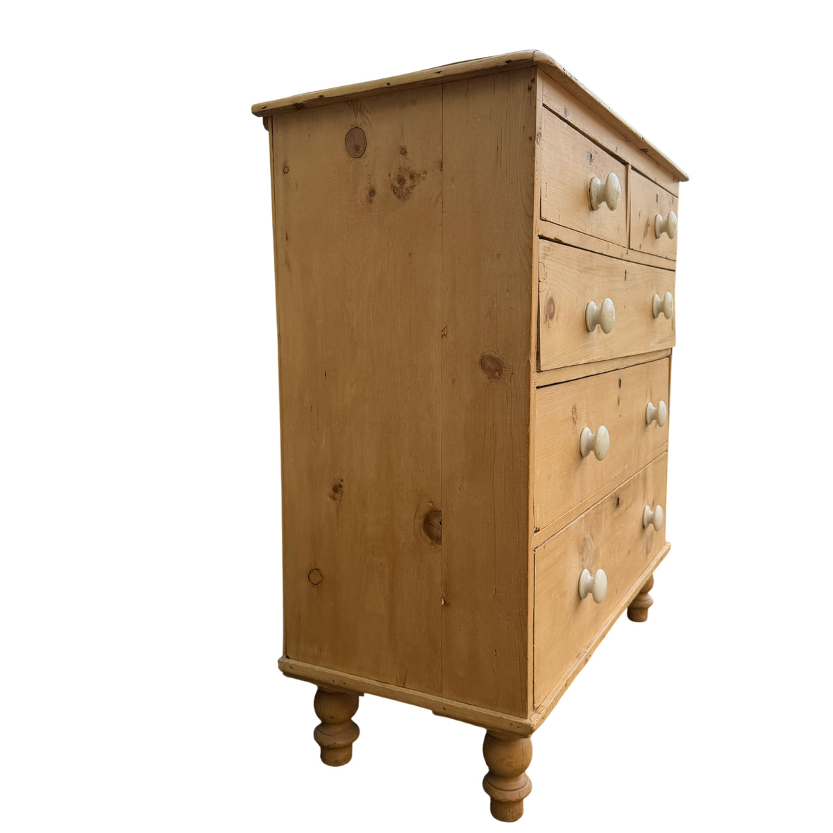 Close-up of top drawers and worn pine surface on Victorian chest