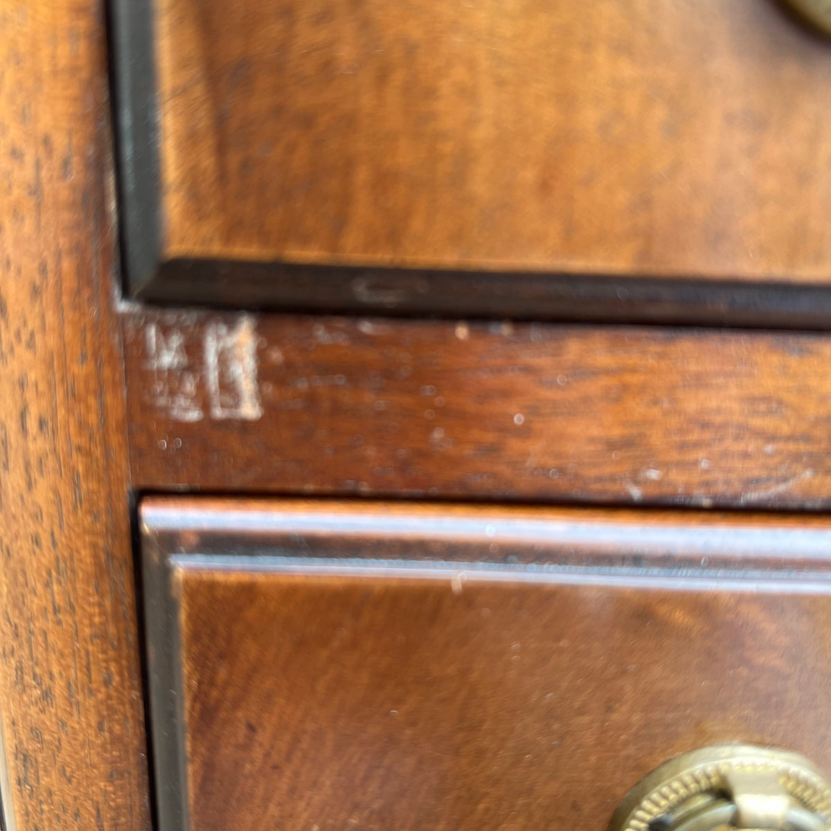 Three-quarter view of vintage chest of drawers with mahogany finish and multiple drawers