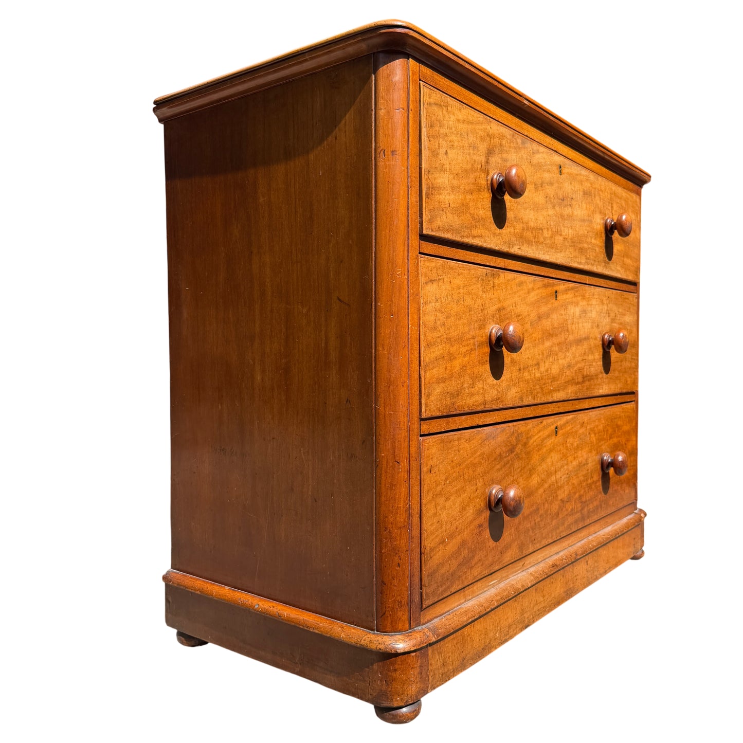 Front view Victorian pine chest of drawers with key escutcheons and bun feet