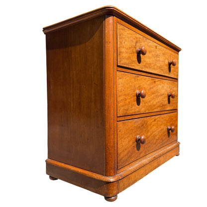 Front view Victorian pine chest of drawers with key escutcheons and bun feet