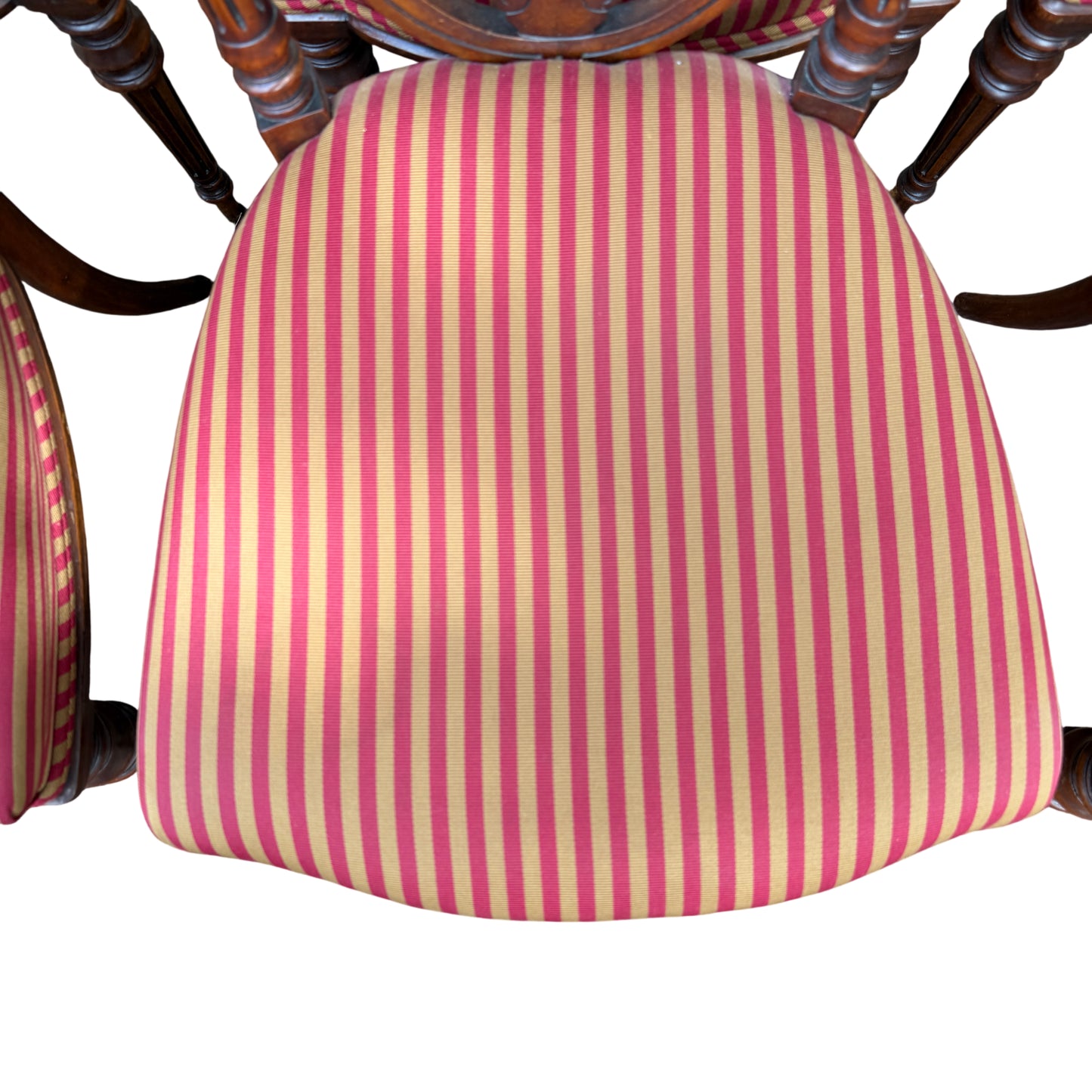 Top view showing six striped upholstered dining chair seats in a row