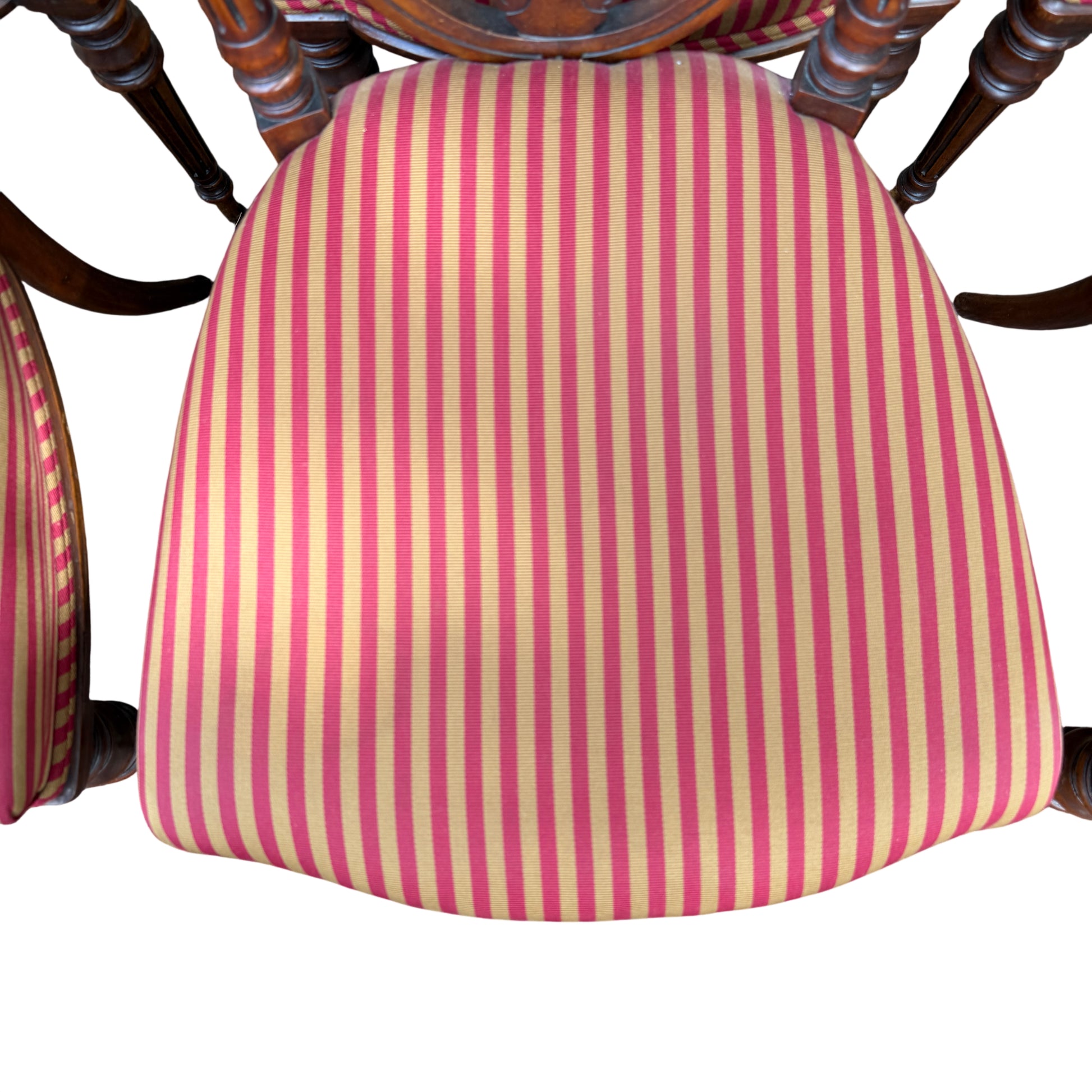 Top view showing six striped upholstered dining chair seats in a row
