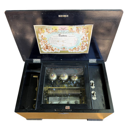 Open Victorian Swiss cylinder music box showing pinned brass cylinder and steel comb