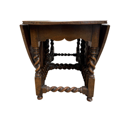 Side profile of oak gateleg table with one leaf dropped and barley twist supports