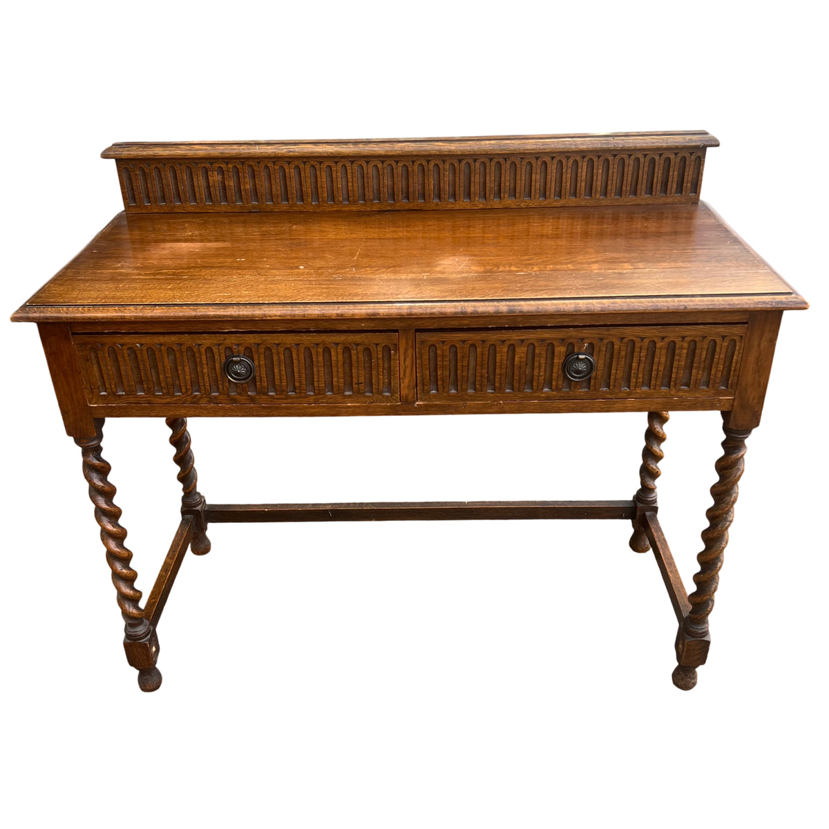 Close-up of carved gallery back and oak top of console table