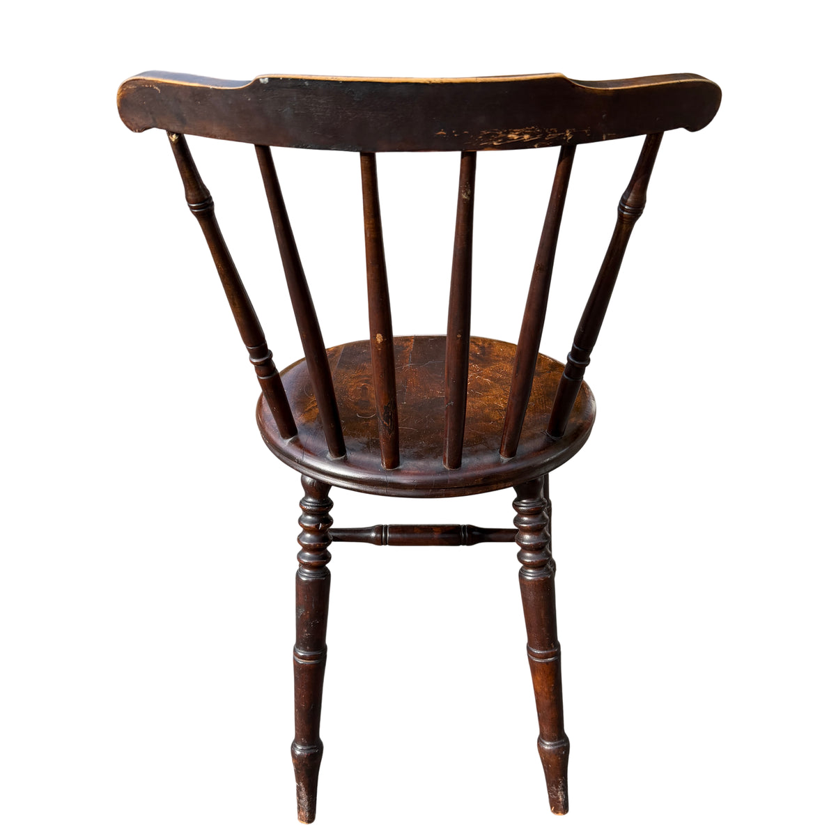 Stickback penny-seat dining chair with slender turned legs and spindle back in dark wood