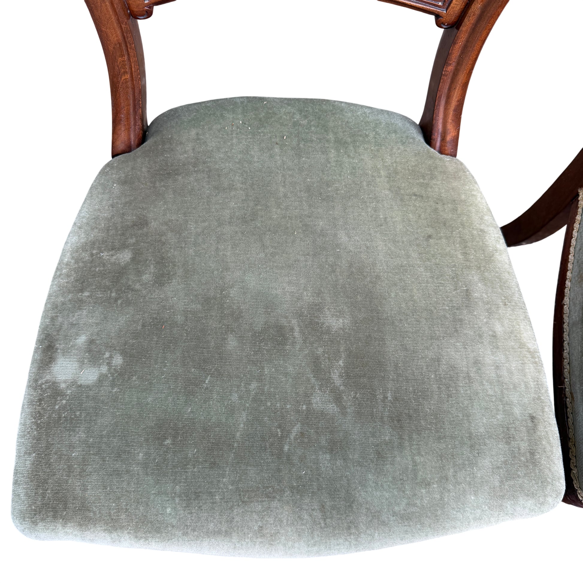 Rear view of chair backs showing carved splats and shaped top rails