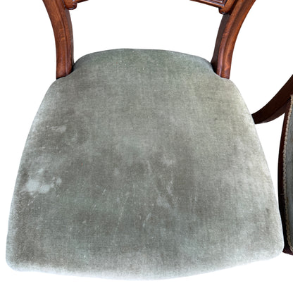 Rear view of chair backs showing carved splats and shaped top rails