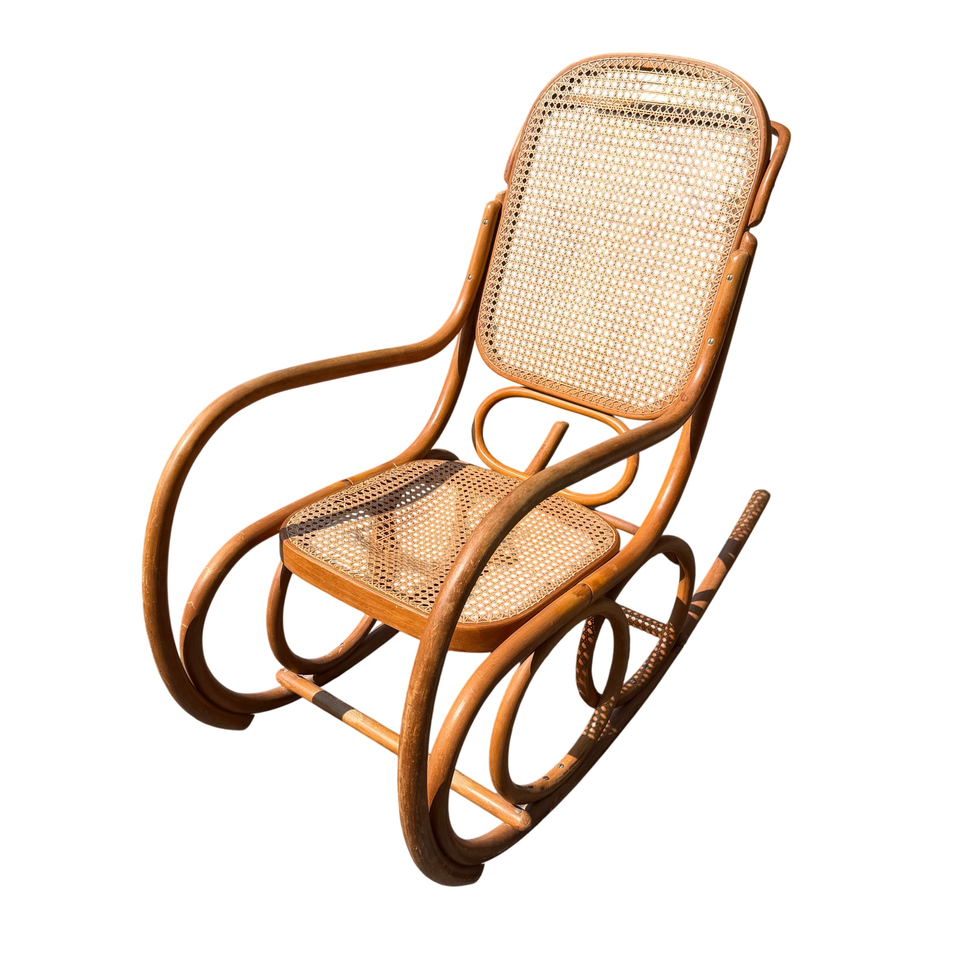 Vintage bentwood rocking chair with caned seat and back in honey wood finish