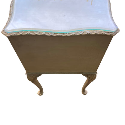 Cream painted bedside cabinet with shaped glass top and decorative moulded edge