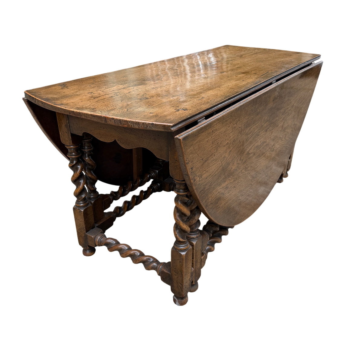 Historic nail heads and small filled holes visible in oak tabletop surface