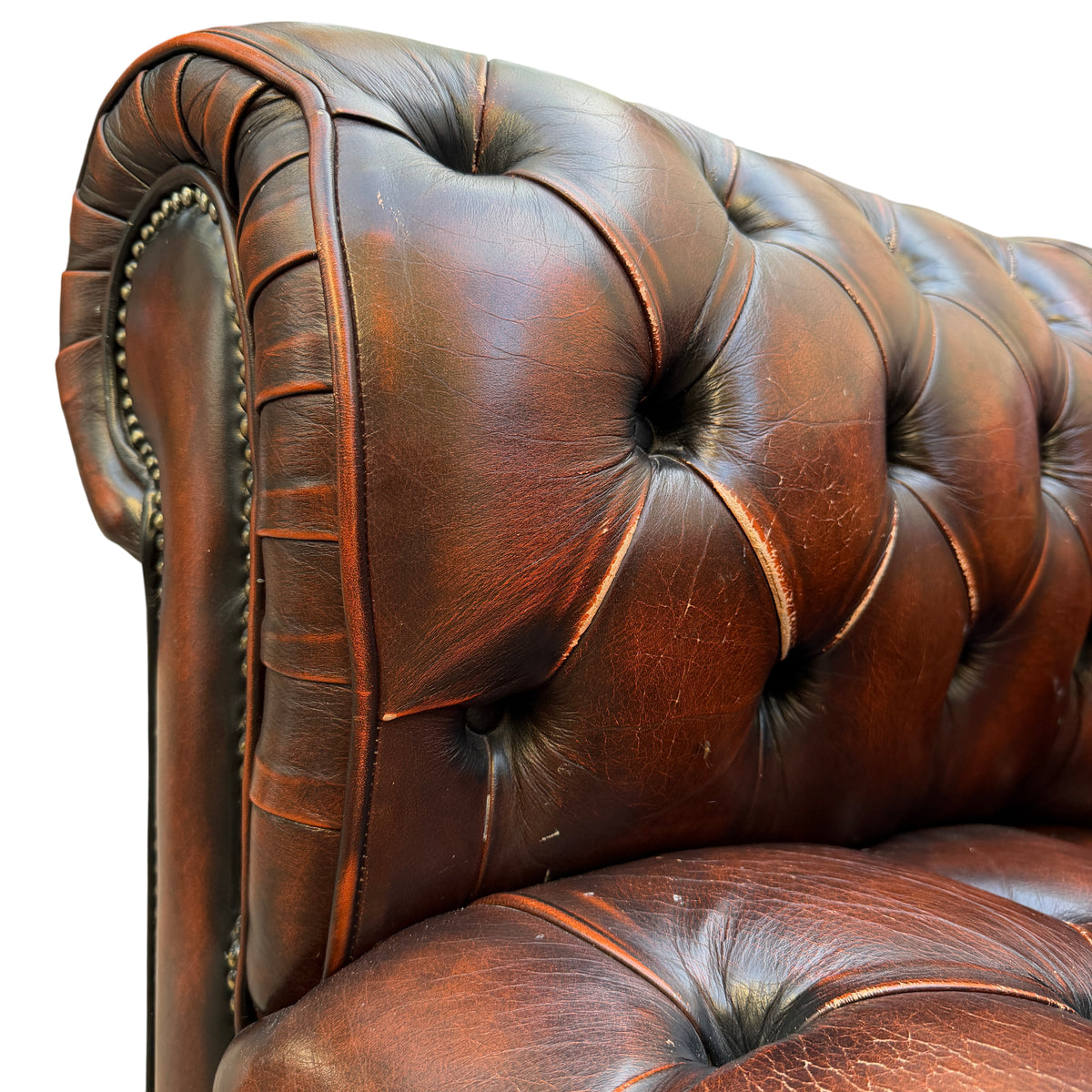 Overall view of a tufted brown leather Chesterfield armchair suitable for living room