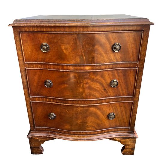 Vintage mahogany bedside chest of drawers with serpentine front and brass ring handles