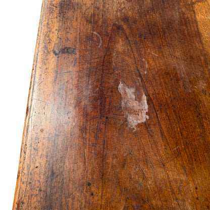 Low oak coffee table with stretcher base photographed on pavement