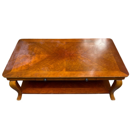 Edge detail with visible small chips and finish wear on wood-veneer coffee table