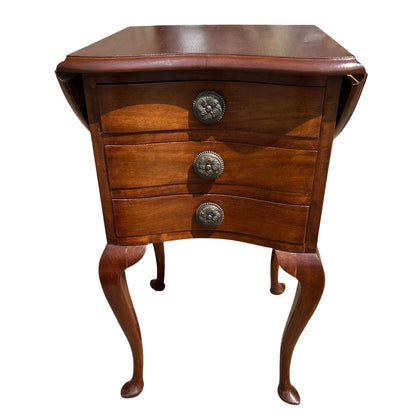 Compact bedside cabinet with three curved-front drawers and decorative metal knobs