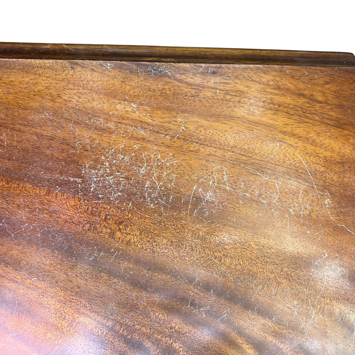 Detail of drawer fronts showing mahogany veneer grain and patina