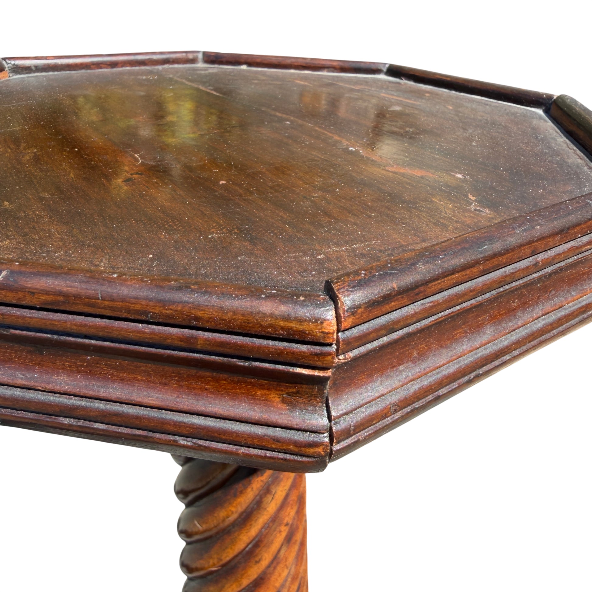 Close detail of carved moulding between column and base on mahogany stand