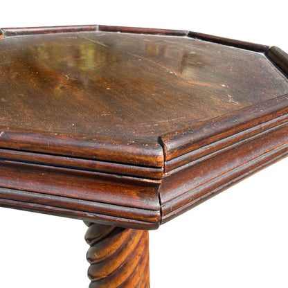 Close detail of carved moulding between column and base on mahogany stand