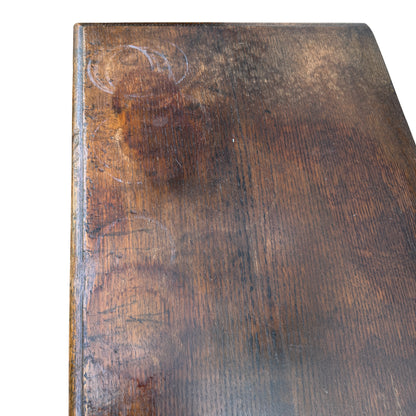 Lower section of oak cabinet showing two drawers and decorative brass handles