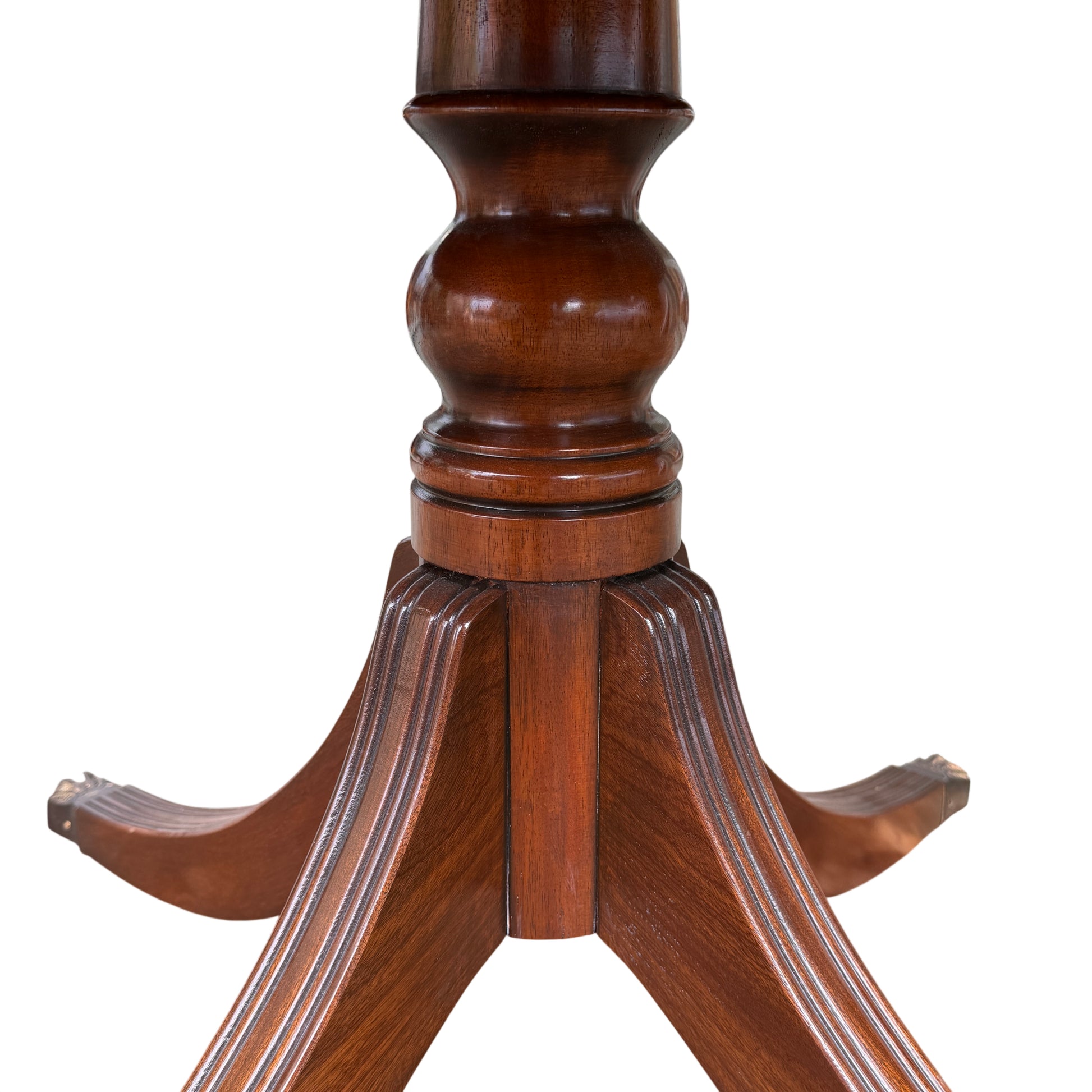Underside view of pedestal base and leg join of the round dining table