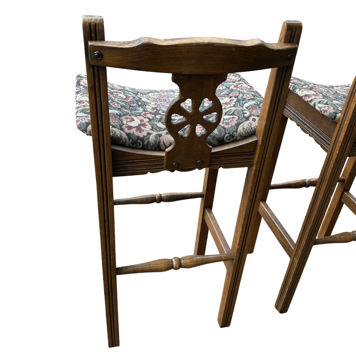 Close-up of patterned upholstery on an Old Charm oak bar stool seat