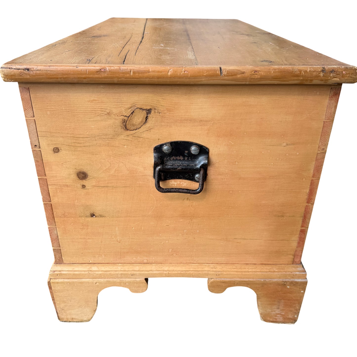 Base and shaped feet of pine blanket box showing simple carved feet