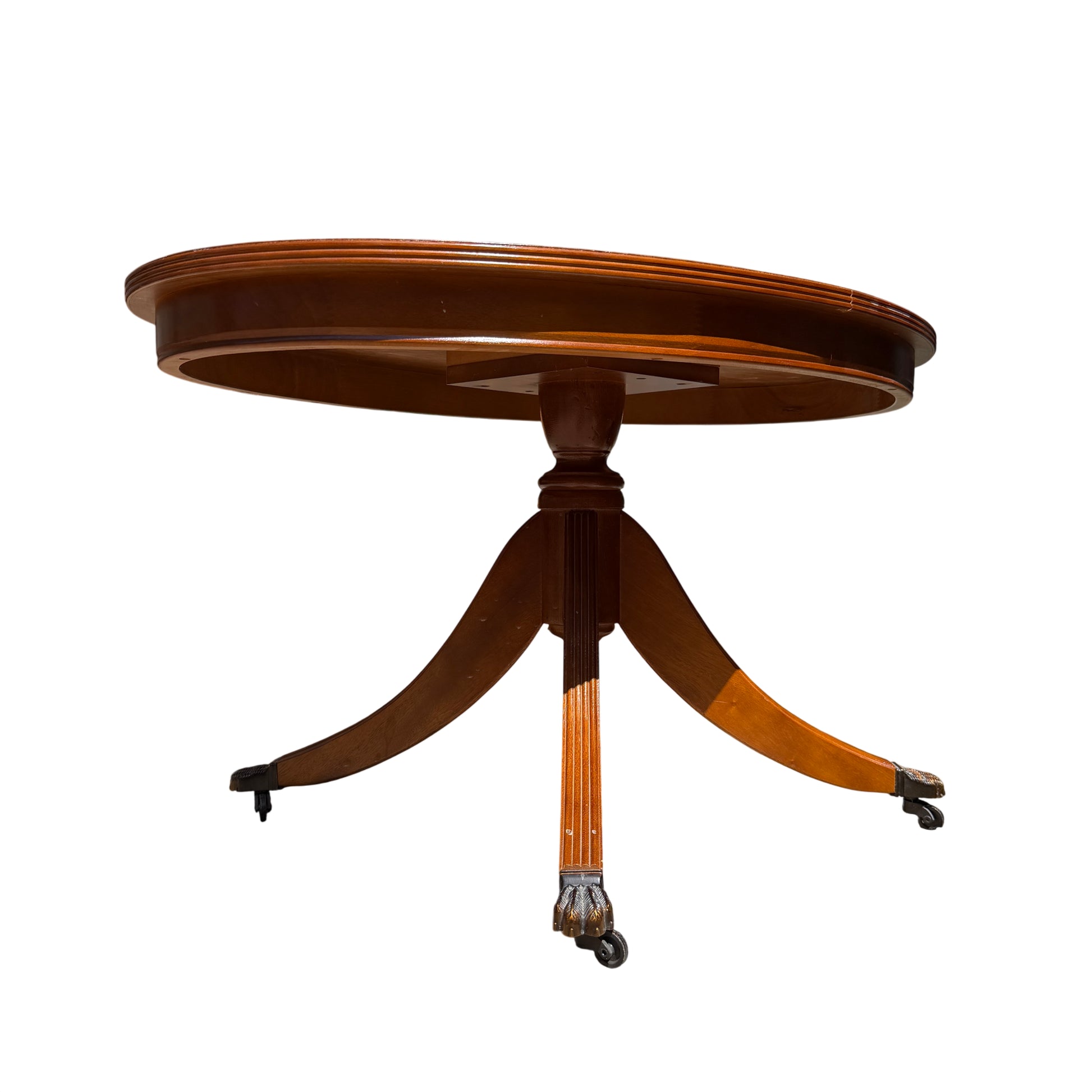 Oval wooden dining table with banded edge and polished mahogany‑tone surface