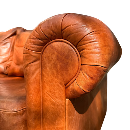 Wesley-Barrell two-seater leather sofa positioned in front of shop window