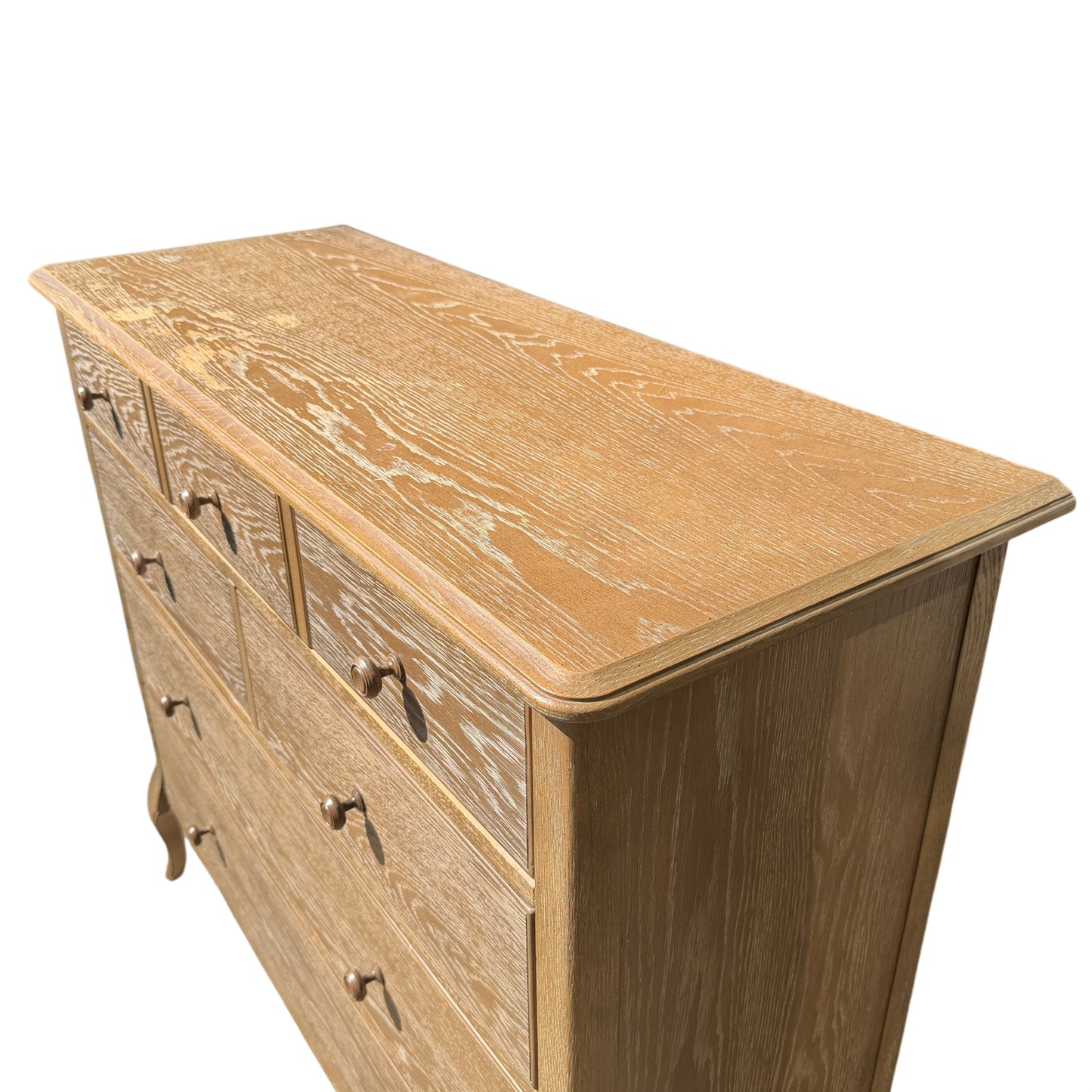 Angled low-level shot showing chest legs, shadow and surface texture of painted oak finish