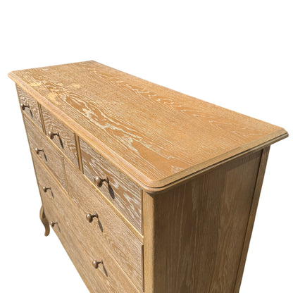 Angled low-level shot showing chest legs, shadow and surface texture of painted oak finish