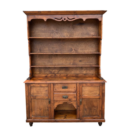 Large vintage pine dresser with three open shelves above drawers and cupboards in medium brown stain