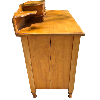 Close-up of brass handle and escutcheon on pine chest of drawers