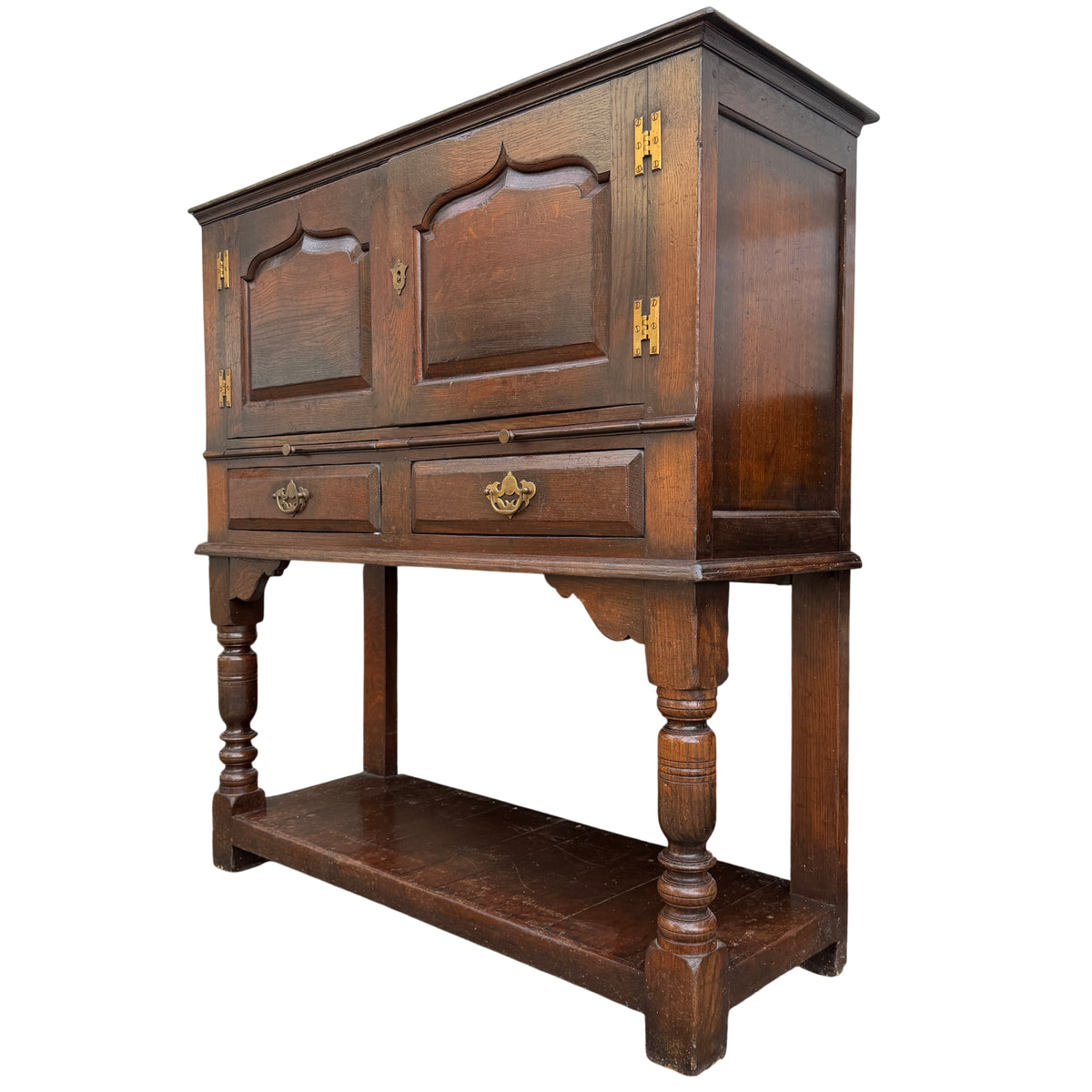 Vintage oak cabinet on stand with two arched panel doors and turned legs