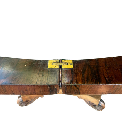 Side view of rosewood tilt-top card table with carved apron detail