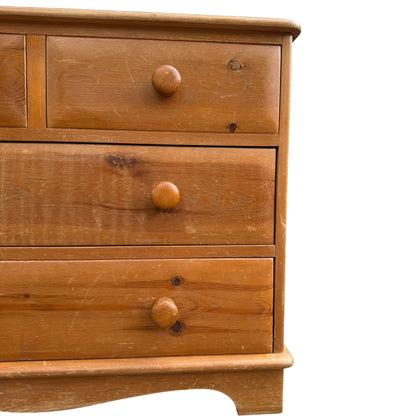 Lower drawers of pine chest with turned knobs and light scuffs to finish