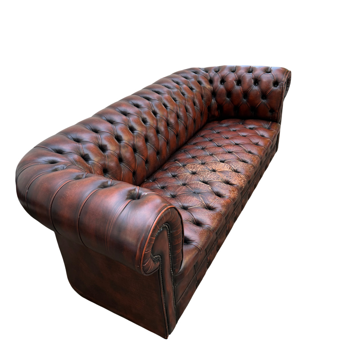 Side profile of Chesterfield sofa showing rolled arm and stud trim