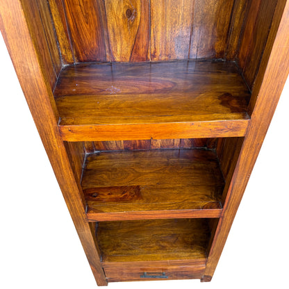 Mid section of narrow solid wood bookcase showing shelf divider and grain