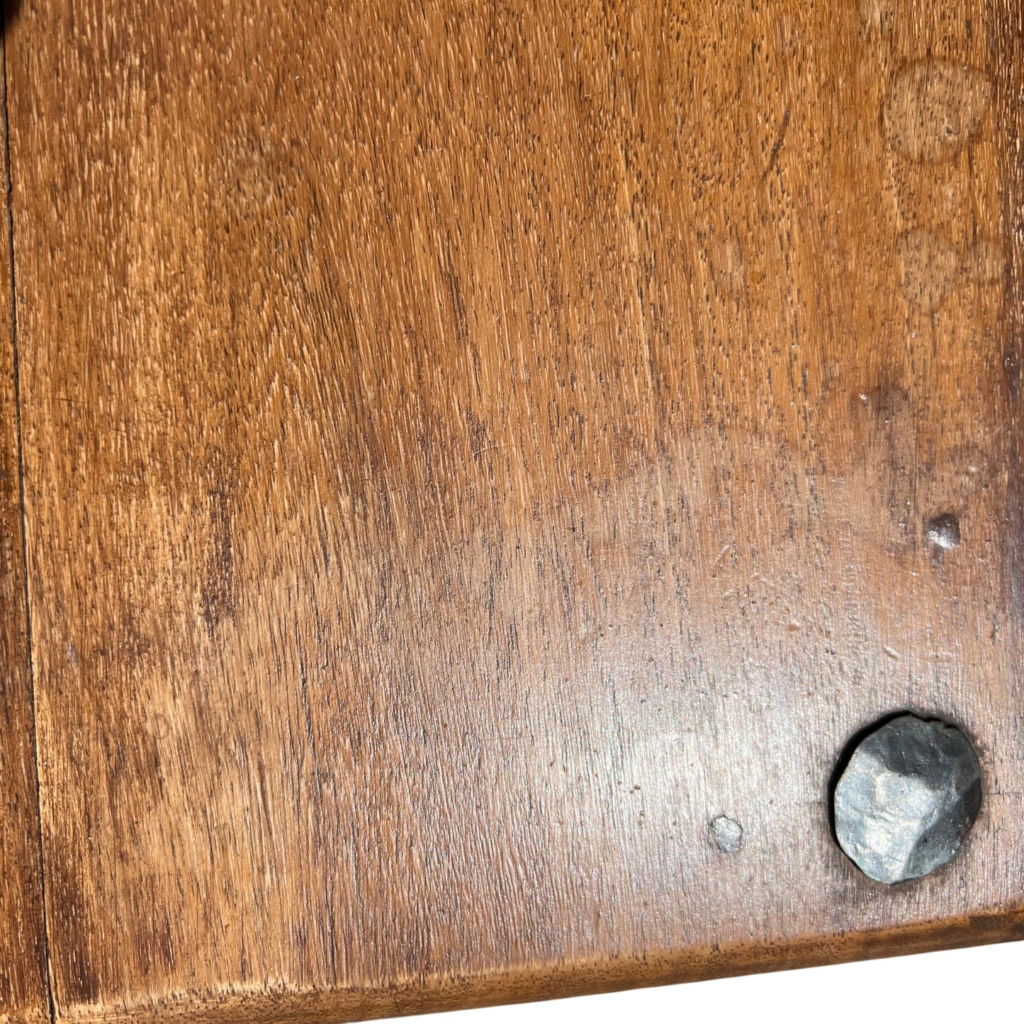 Close-up of oak table top showing plank joins and iron fixing discs