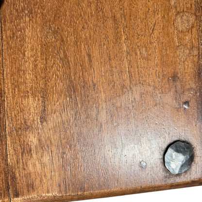 Close-up of oak table top showing plank joins and iron fixing discs